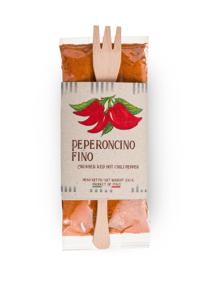 packet of dried calabrian chilli powder with wooden mixing spoon